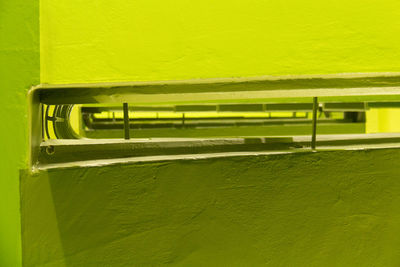 Close-up of text on green yellow wall