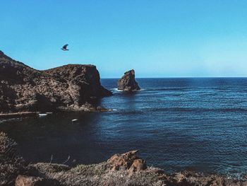 Scenic view of sea against clear blue sky