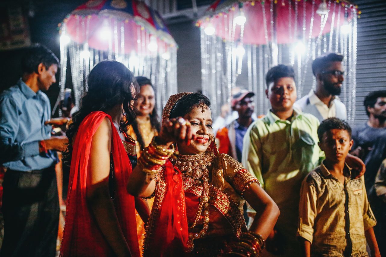 group of people, men, women, real people, indoors, adult, traditional clothing, large group of people, standing, crowd, lifestyles, emotion, casual clothing, young adult, smiling, focus on foreground, nightlife