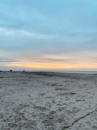 Scenic view of beach against sky during sunset