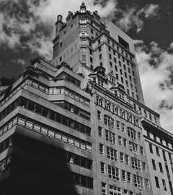 Low angle view of buildings against cloudy sky