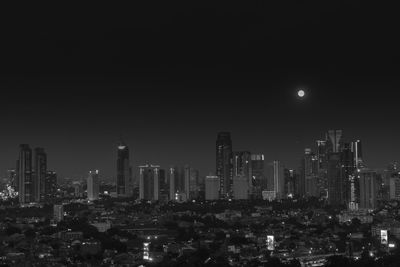 Illuminated cityscape against sky at night