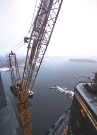 High angle view of crane in sea against sky