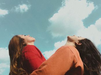 Portrait of young woman against sky