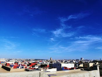 High angle shot of townscape against blue sky