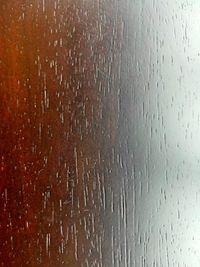 Full frame shot of wet glass window