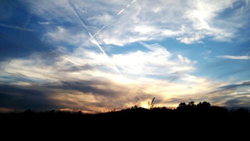 Silhouette landscape against sky during sunset