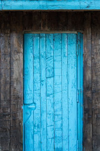 Closed blue door of old building