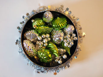 Directly above shot of christmas decorations in container on table