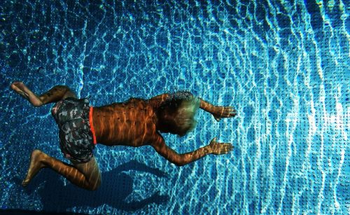 High angle view of man swimming in pool