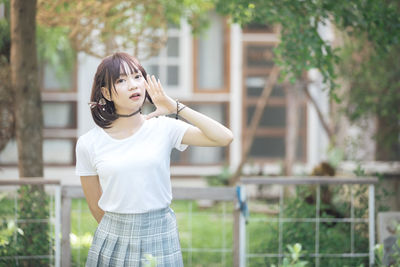 Portrait of a beautiful young woman standing outdoors