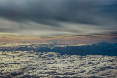 Aerial view of landscape against cloudy sky during sunset