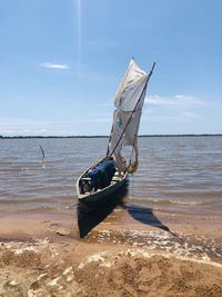 Ship on beach against sky