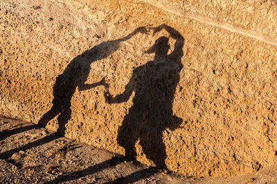 Shadow of woman on sand
