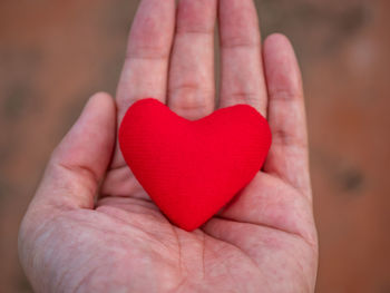 Close-up of hand holding heart shape