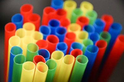 Close-up of colorful drinking straws against white background