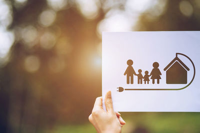 Close-up of people with hands against blurred background