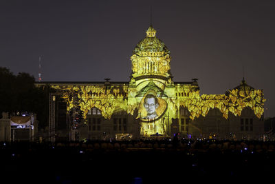 Illuminated building against sky at night