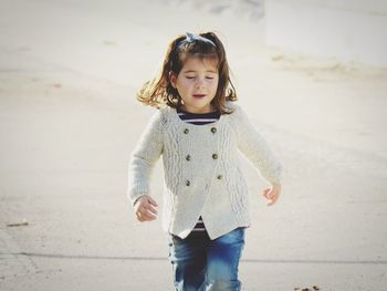 Cute girl standing on beach