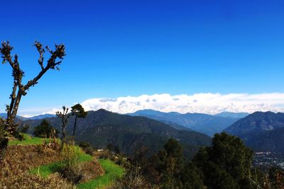 Scenic view of mountains against clear blue sky