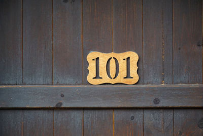 Close-up of text on wooden wall