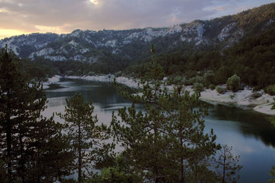 Scenic view of river with mountains in background