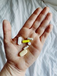 Close-up of hand holding pills