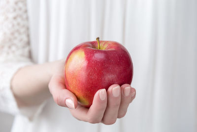 Close-up of woman holding apple