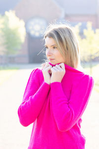 Portrait of young woman standing outdoors