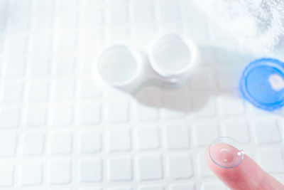 Close-up of hand on glass table