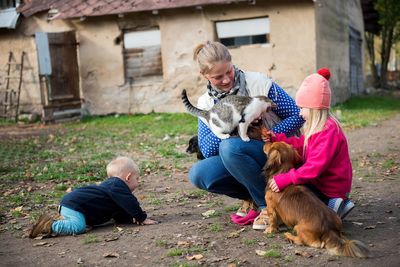 Rear view of people with dogs