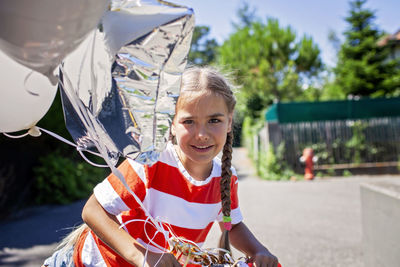 Portrait of young woman holding umbrella
