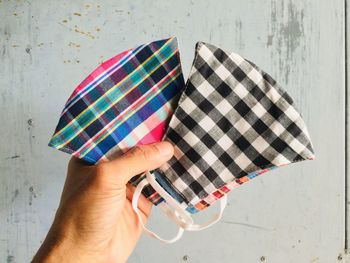 Close-up of person holding multi colored umbrella