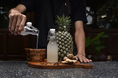 Midsection of man preparing food on table