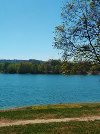 Scenic view of lake against clear blue sky