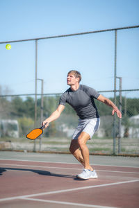 Full length of woman exercising on court