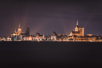 Illuminated buildings in city at night