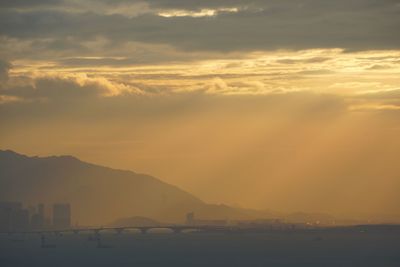 Scenic view of silhouette mountains against sky during sunset