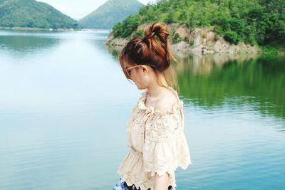 Woman standing by lake
