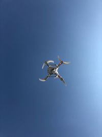 Low angle view of helicopter flying in sky