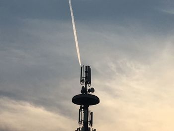 Low angle view of silhouette tower against sky