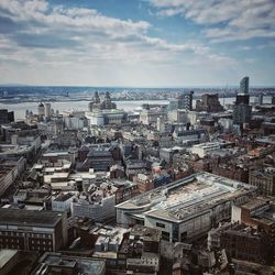 High angle view of townscape by sea against sky