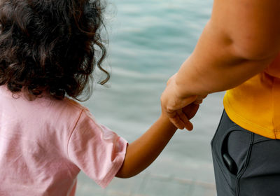 Rear view of girl and mother