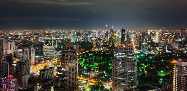 Aerial view of illuminated buildings in city at night