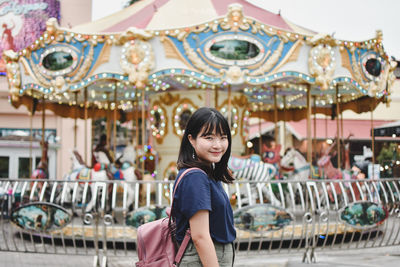 Portrait of smiling young woman at amusement park