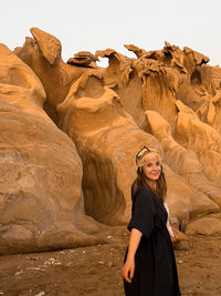 Portrait of woman standing on rock formations