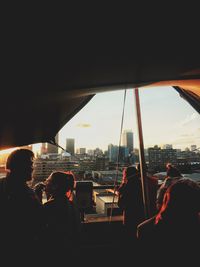 People in city buildings seen through glass window