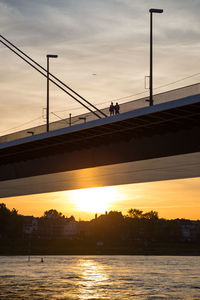Bridge over river at sunset