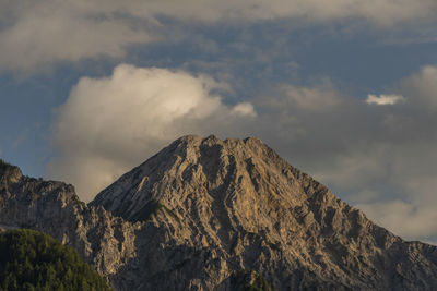 Low angle view of volcanic mountain against sky