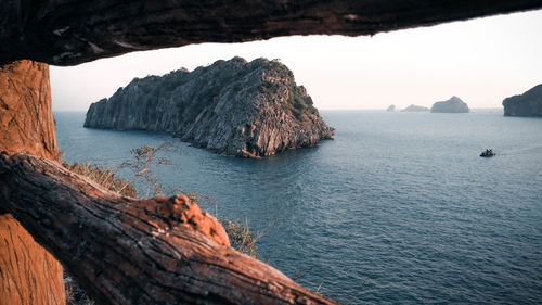 Rock formations in sea against sky